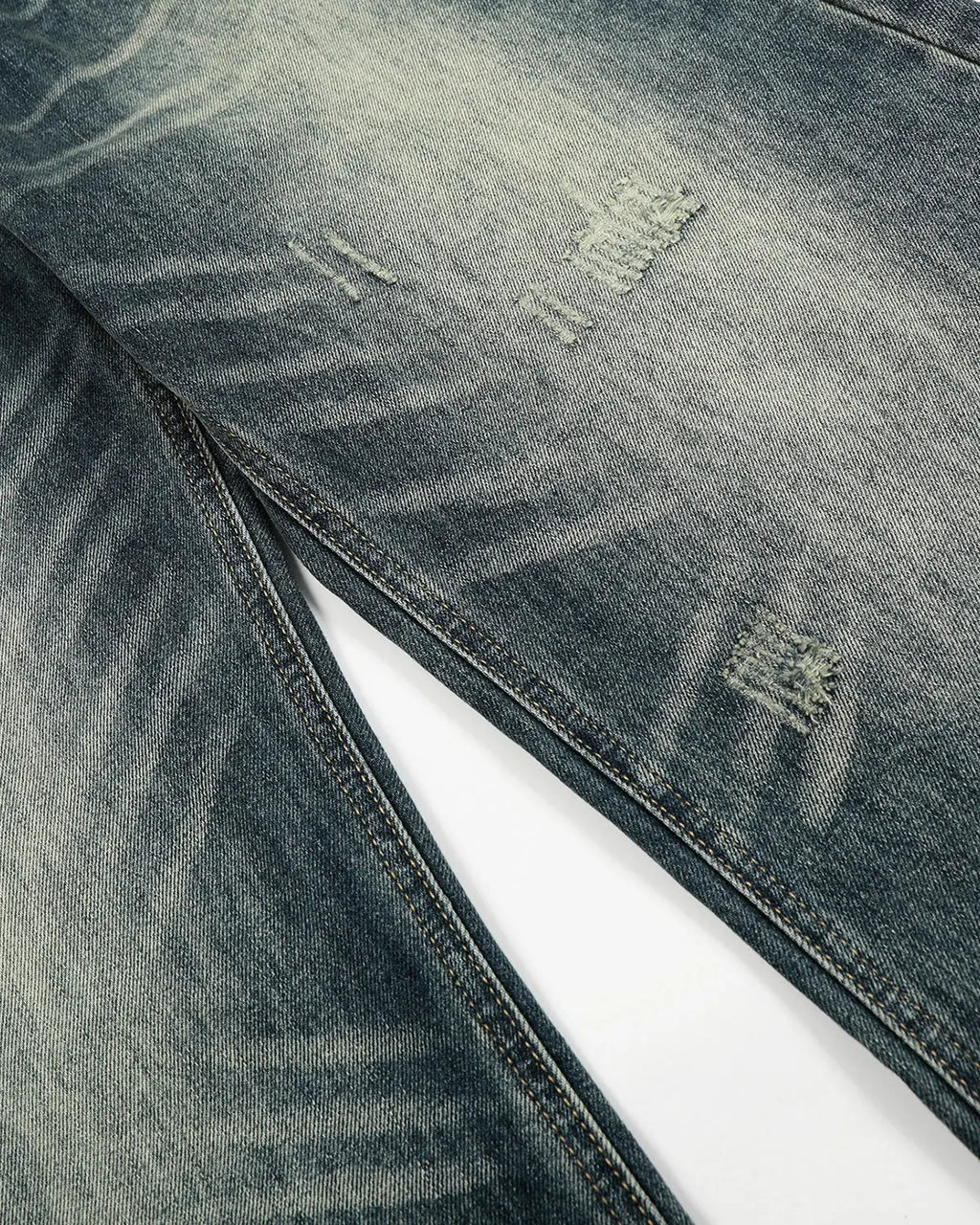 Acid washed ripped baggy barrel jeans by INFLATION Streetwear, showing distressed denim with a relaxed fit and distressed details.