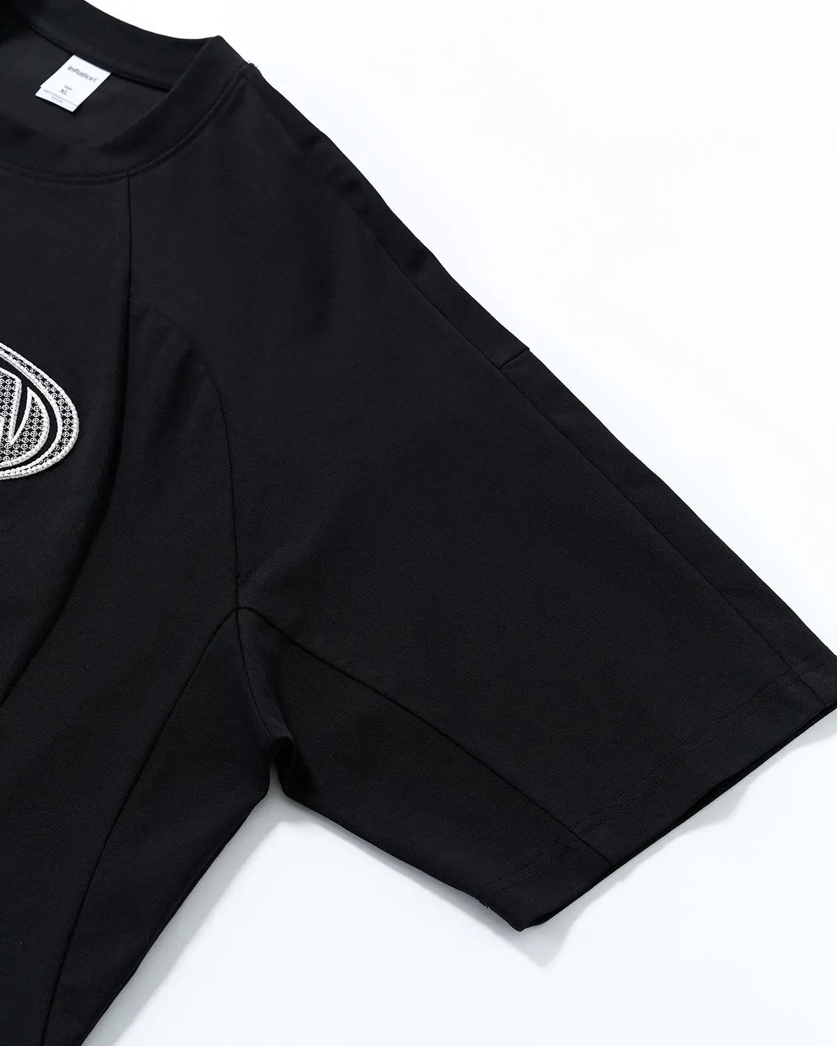 Hollow embroidered graphic T-shirt by INFLATION featuring bold embroidery and streetwear style on soft fabric.