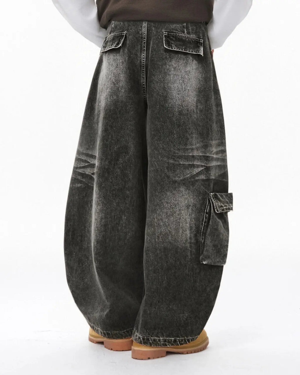 Distressed washed cargo barrel jeans by INFLATION featuring a relaxed streetwear style with faded and ripped details.
