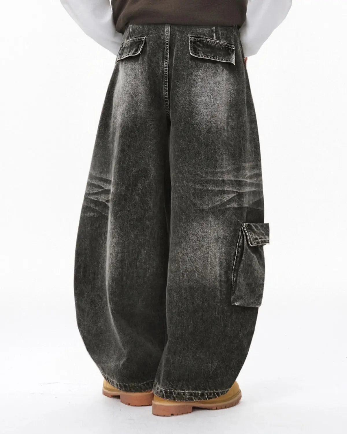 Distressed washed cargo barrel jeans by INFLATION featuring a relaxed streetwear style with faded and ripped details.