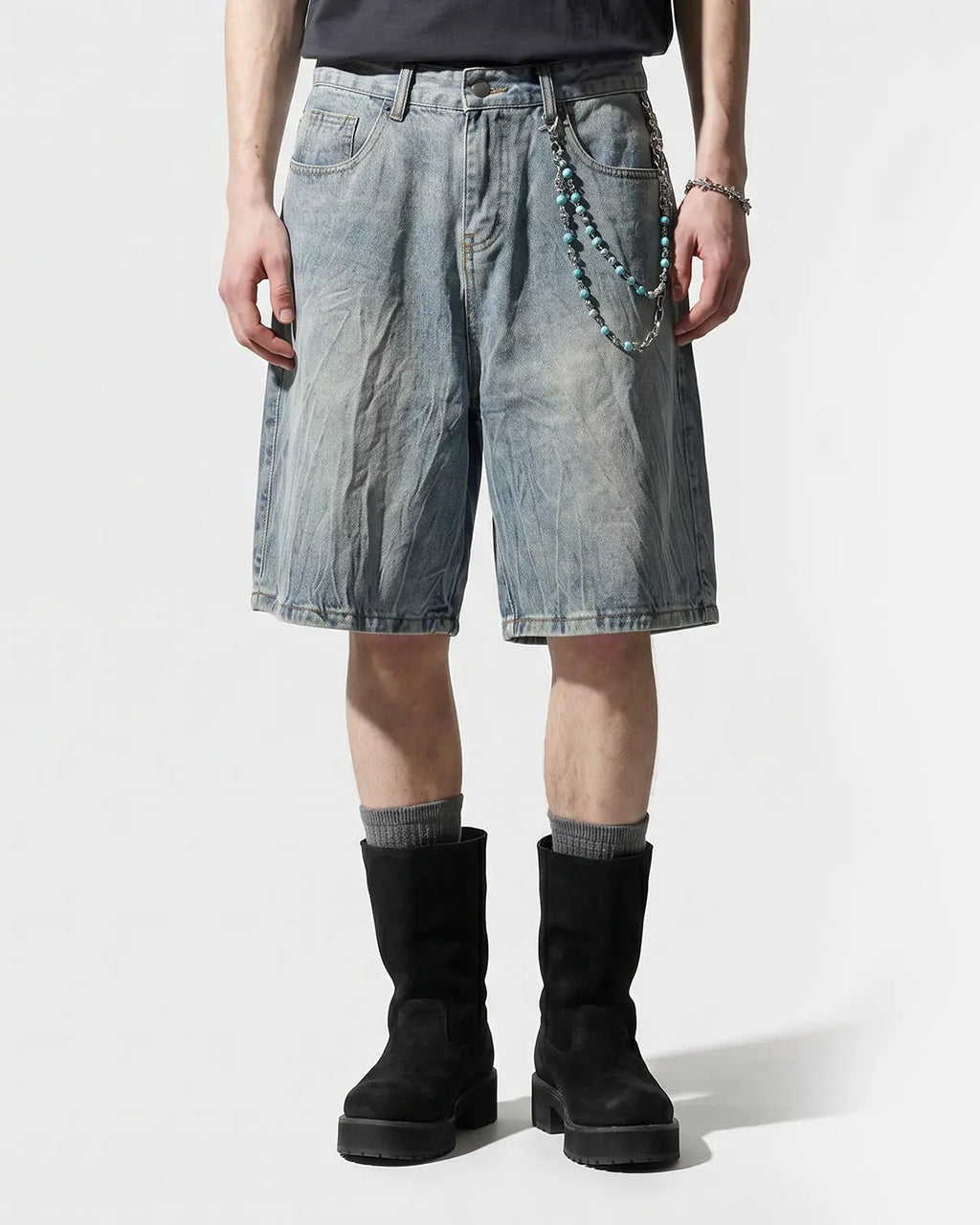 Textured washed longline jorts by INFLATION Streetwear, showing distressed denim pants with a relaxed, longline fit.