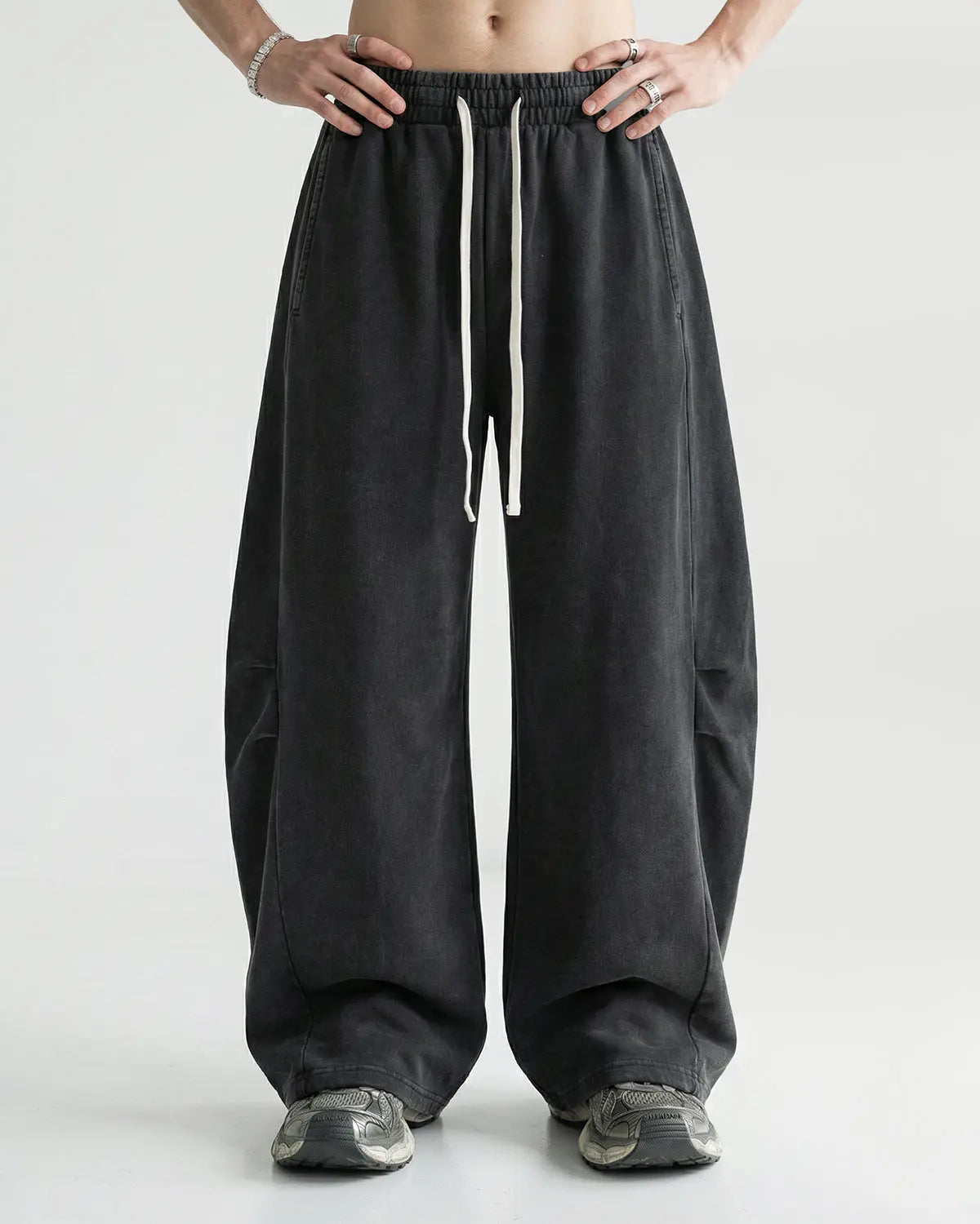 Distressed acid washed barrel sweatpant by INFLATION Streetwear, showing the relaxed fit and faded, washed-out denim look.