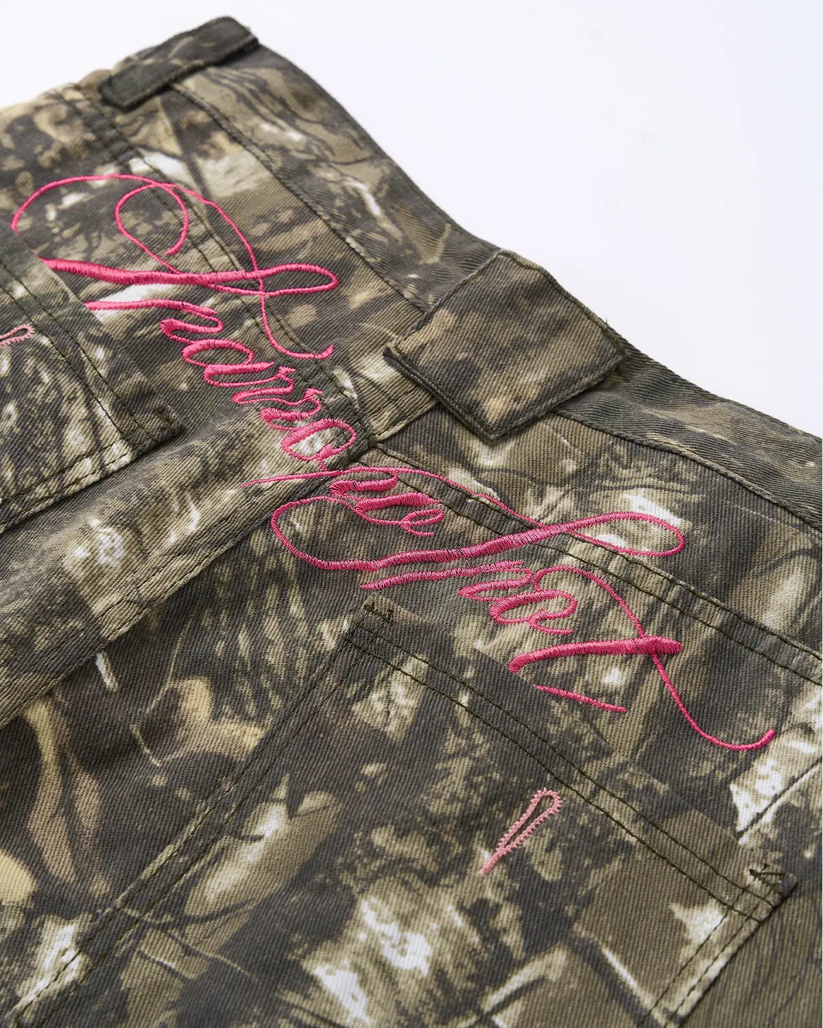Pink embroidered camo baggy pants by INFLATION Streetwear featuring relaxed fit and detailed embroidery, casual streetwear style.