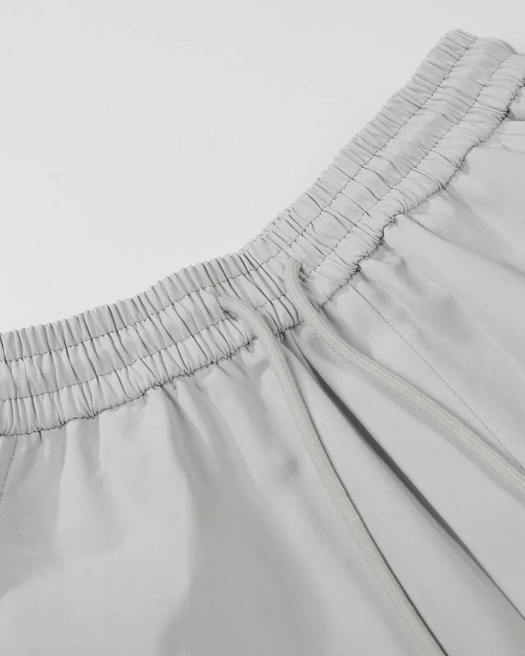 Inflation Streetwear contrast panel baggy track pants with black and white color blocking, relaxed fit, and adjustable waistband.