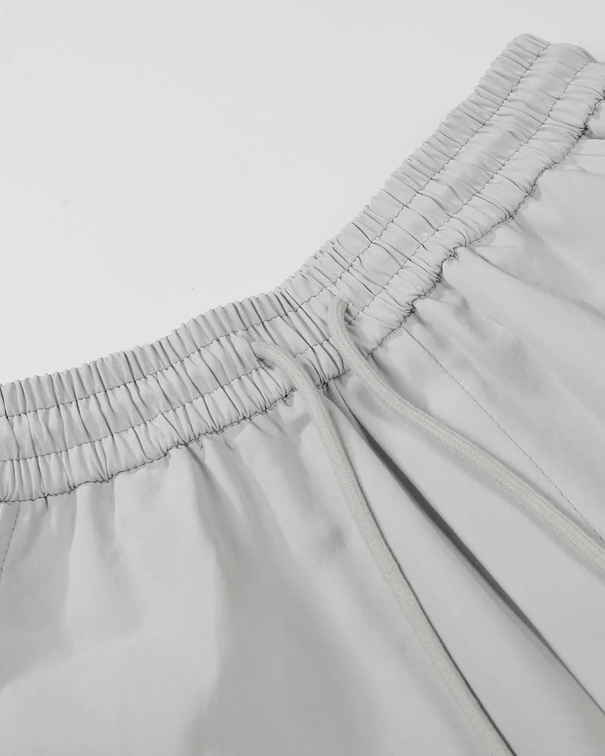Inflation Streetwear contrast panel baggy track pants with black and white color blocking, relaxed fit, and adjustable waistband.