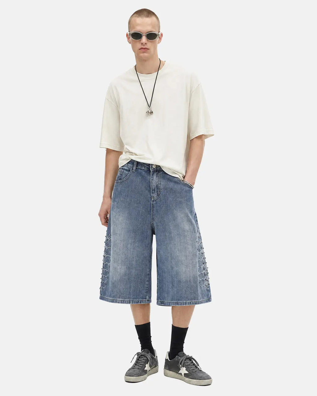Inflation brand studded bamboo weave jorts, denim-style pants with metal stud accents and a casual streetwear fit.