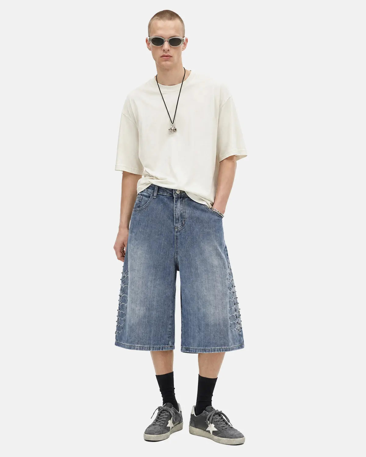 Inflation brand studded bamboo weave jorts, denim-style pants with metal stud accents and a casual streetwear fit.