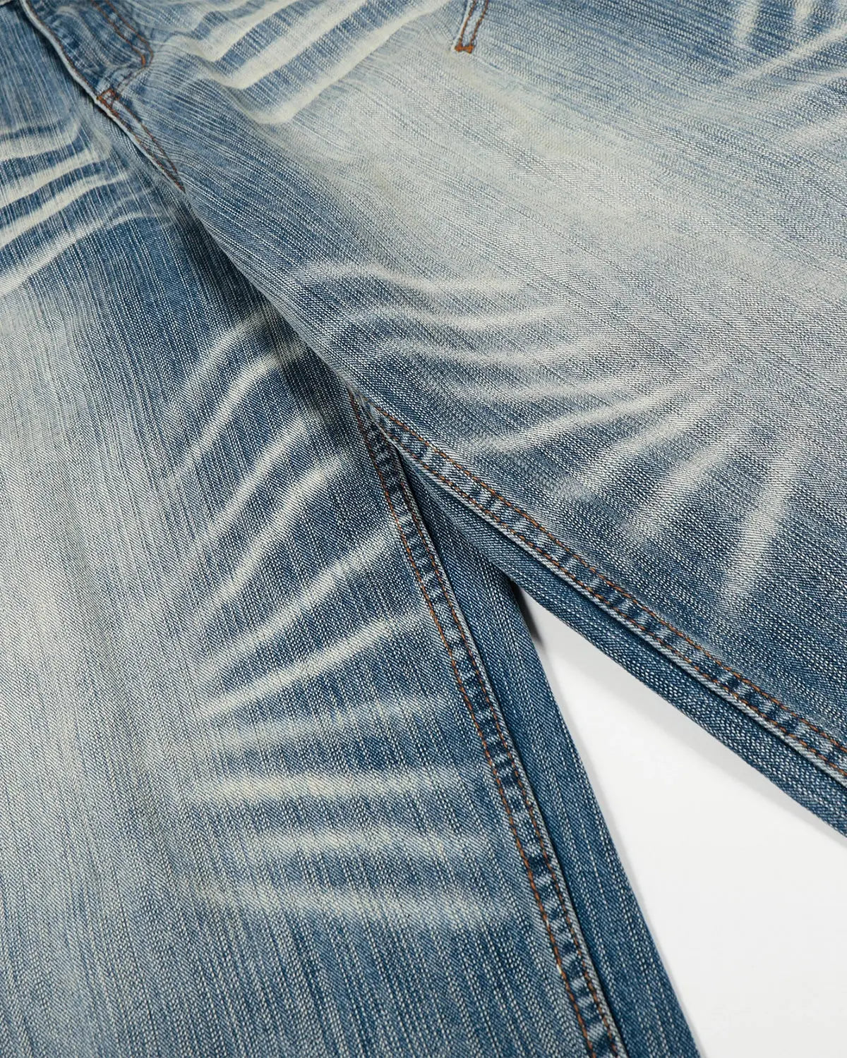 Acid wash whisker bamboo weave jeans by INFLATION, featuring distressed details and a relaxed streetwear style.