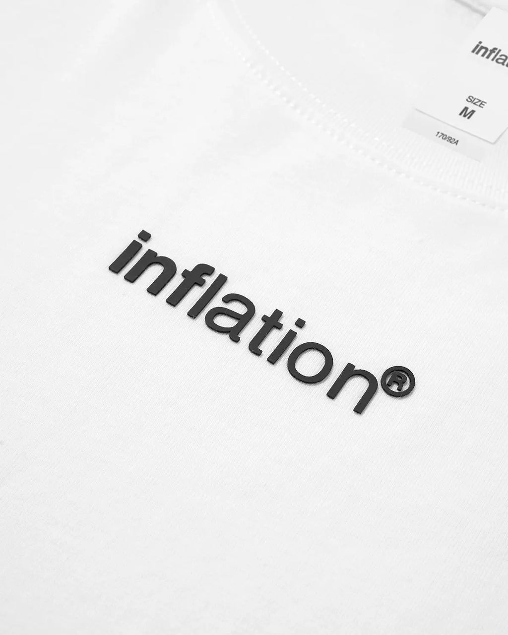 White Logo Boxy Tee from Inflation Streetwear, featuring a minimalist design and a relaxed fit, displayed on a plain background.