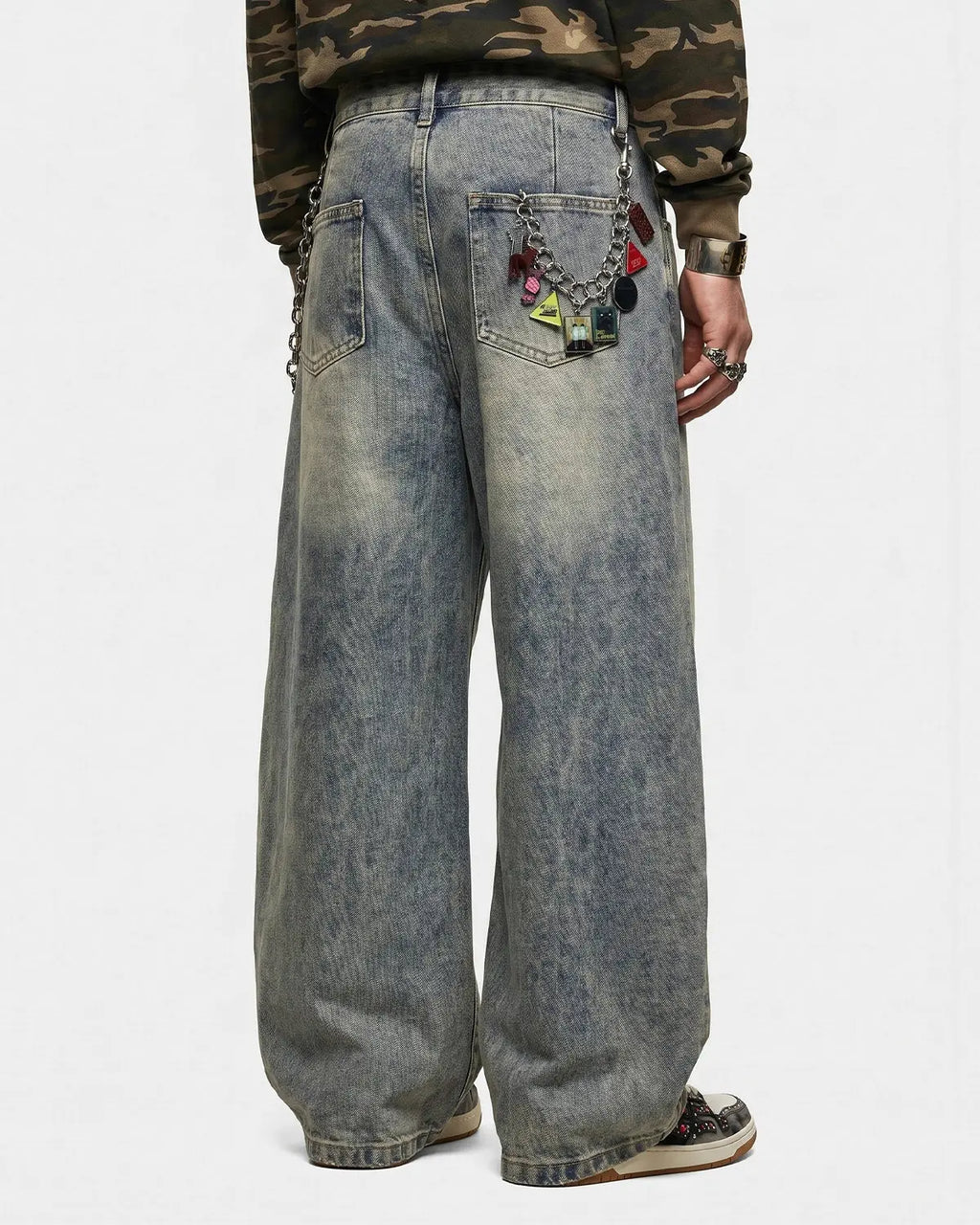 Distressed eyelet barrel jeans by INFLATION featuring a rugged, stylish design with eyelet details and a relaxed fit.