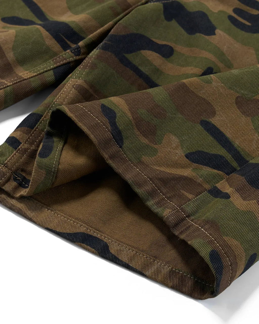 Metal clasp camo shorts by INFLATION, stylish streetwear pants with a military camouflage pattern and metal buckle details.