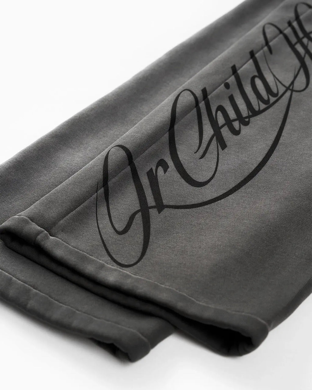 Acid washed black sweatpants by INFLATION with relaxed fit and elastic waistband, casual streetwear style shown in the image.