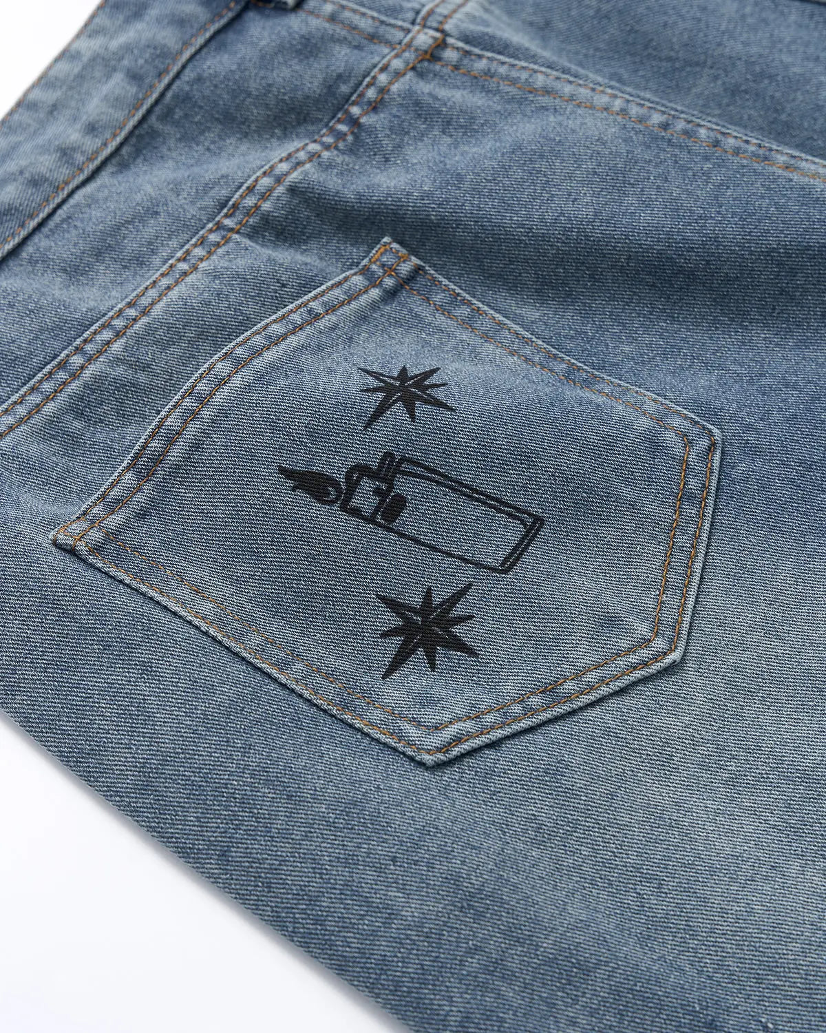 Washed graffiti design longline jorts by INFLATION, streetwear pants with distressed denim and graffiti details, laid flat.