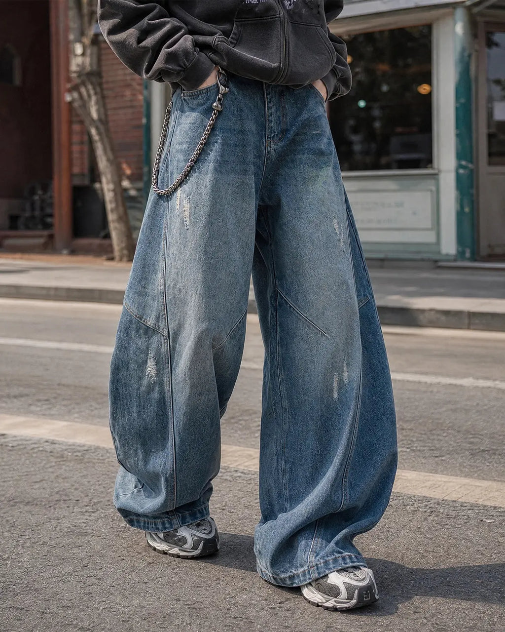 Inflation brand distressed ripped baggy jeans, casual streetwear pants with a relaxed fit and frayed distressed details.