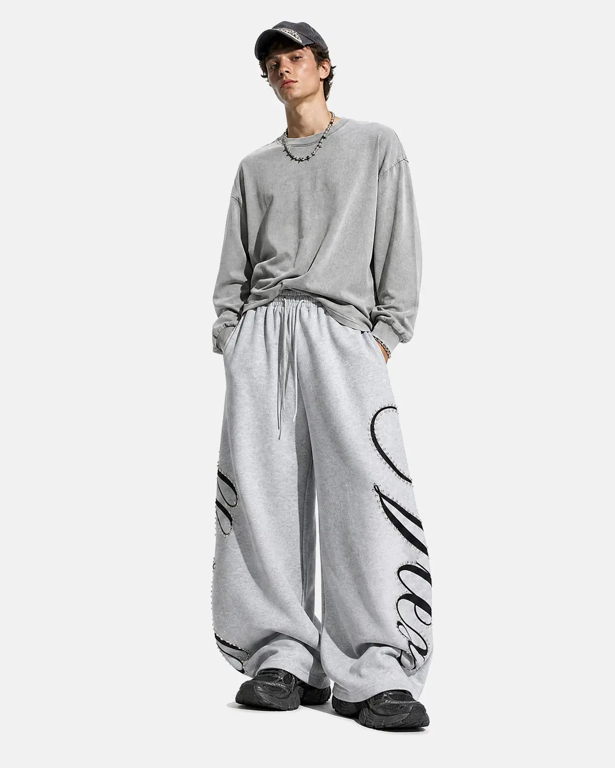 Inflation Streetwear rhinestone script baggy sweatpants with rhinestone embellishments and relaxed fit, shown on a model.