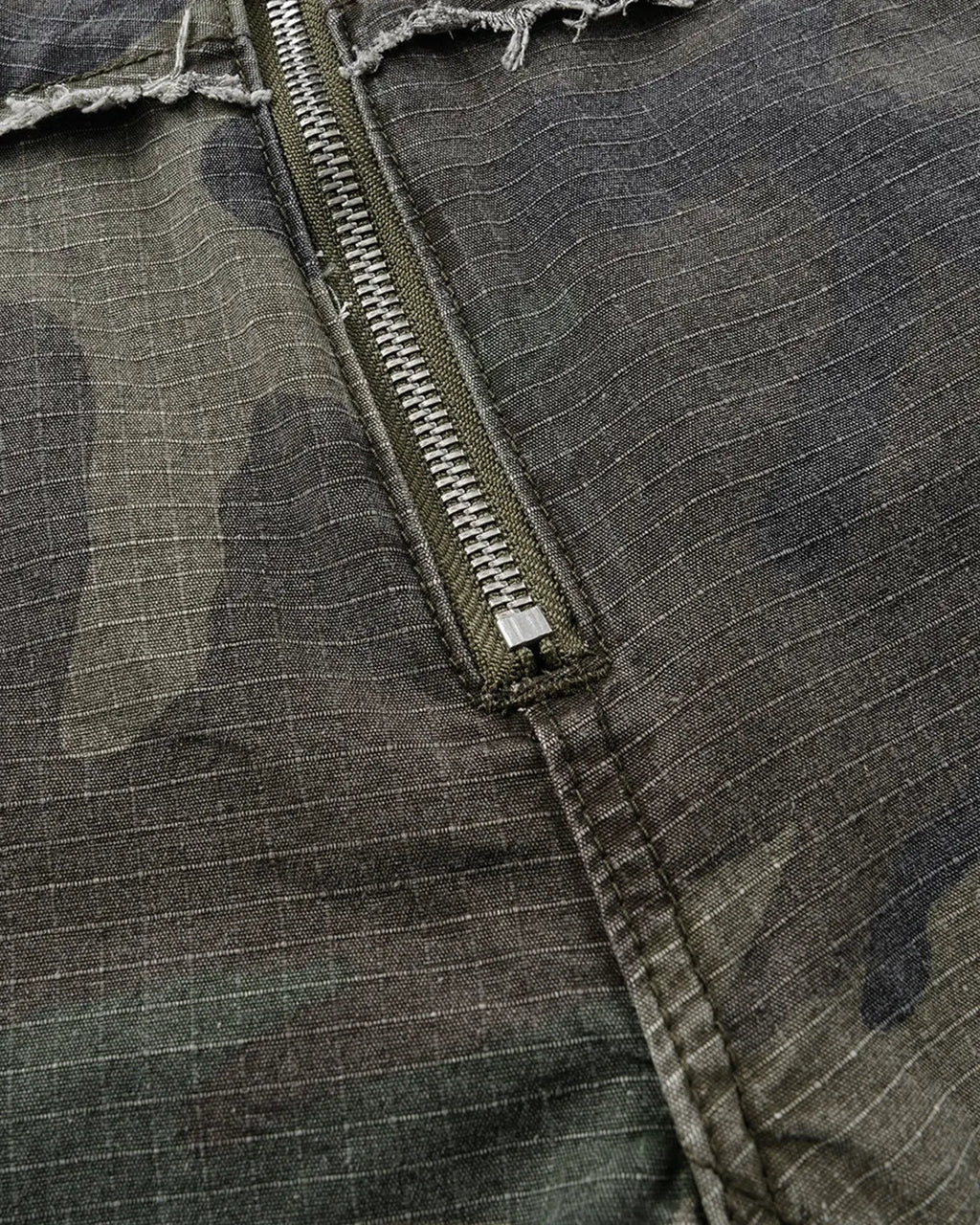 Camo utility longline shorts by INFLATION Streetwear featuring a long, relaxed fit with camouflage pattern and multiple pockets.