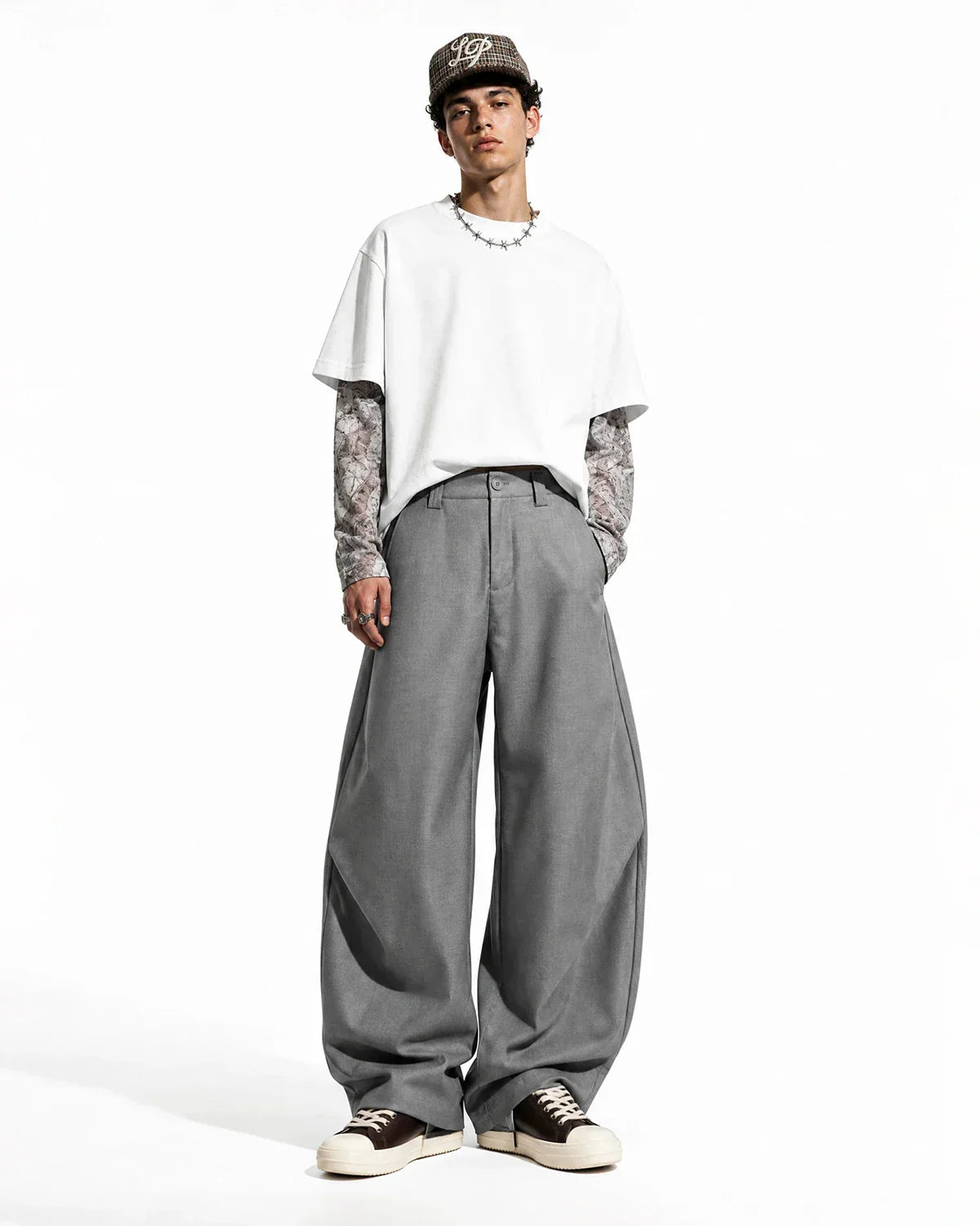 Inflation streetwear pleated barrel tailored pants in neutral fabric, featuring a high waist and relaxed fit.