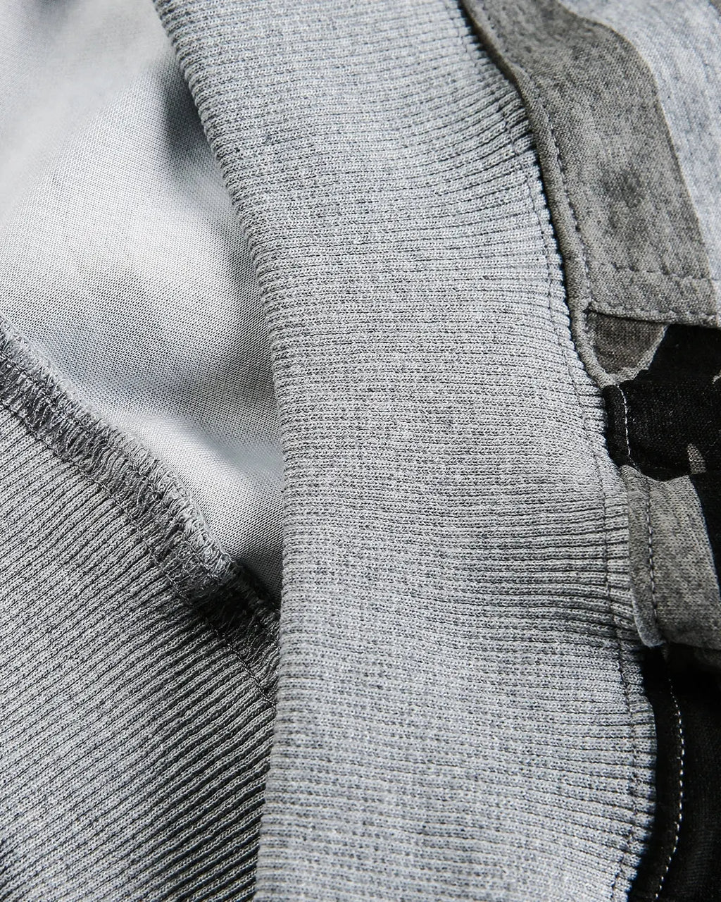 Cropped camouflage zip-up hoodie by INFLATION, streetwear style, with front zipper and adjustable hood on a model.