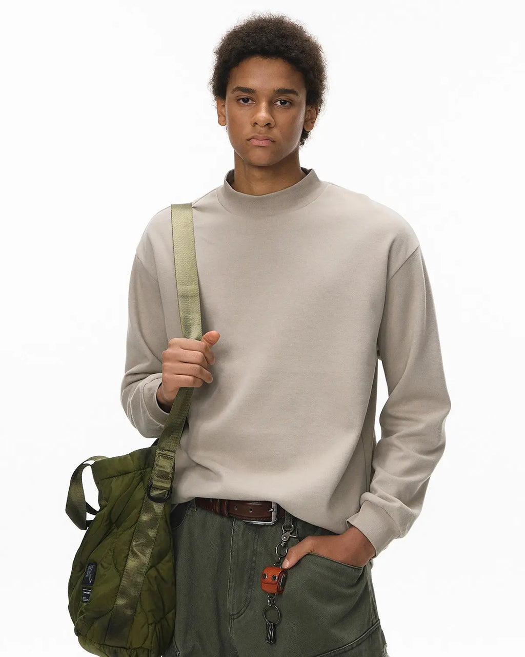 Soft Touch Mock Neck Sweatshirt by INFLATION, stylish streetwear with a cozy, soft fabric and a high neck design, displayed on a hanger.
