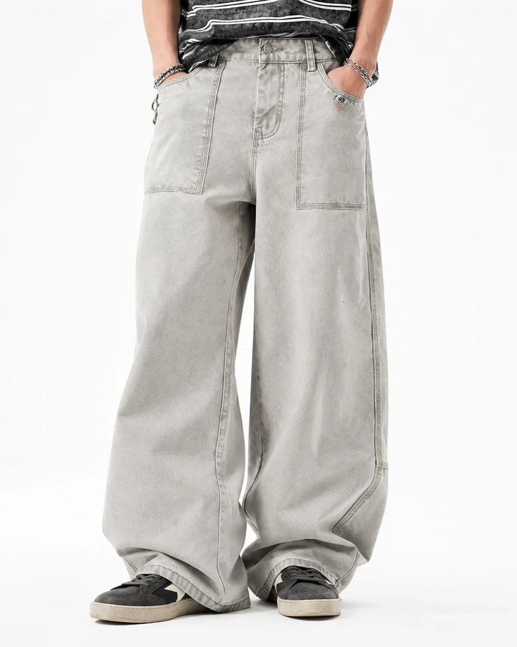 Deconstructed distressed barrel jeans by INFLATION Streetwear featuring ripped details and a relaxed fit on a model.