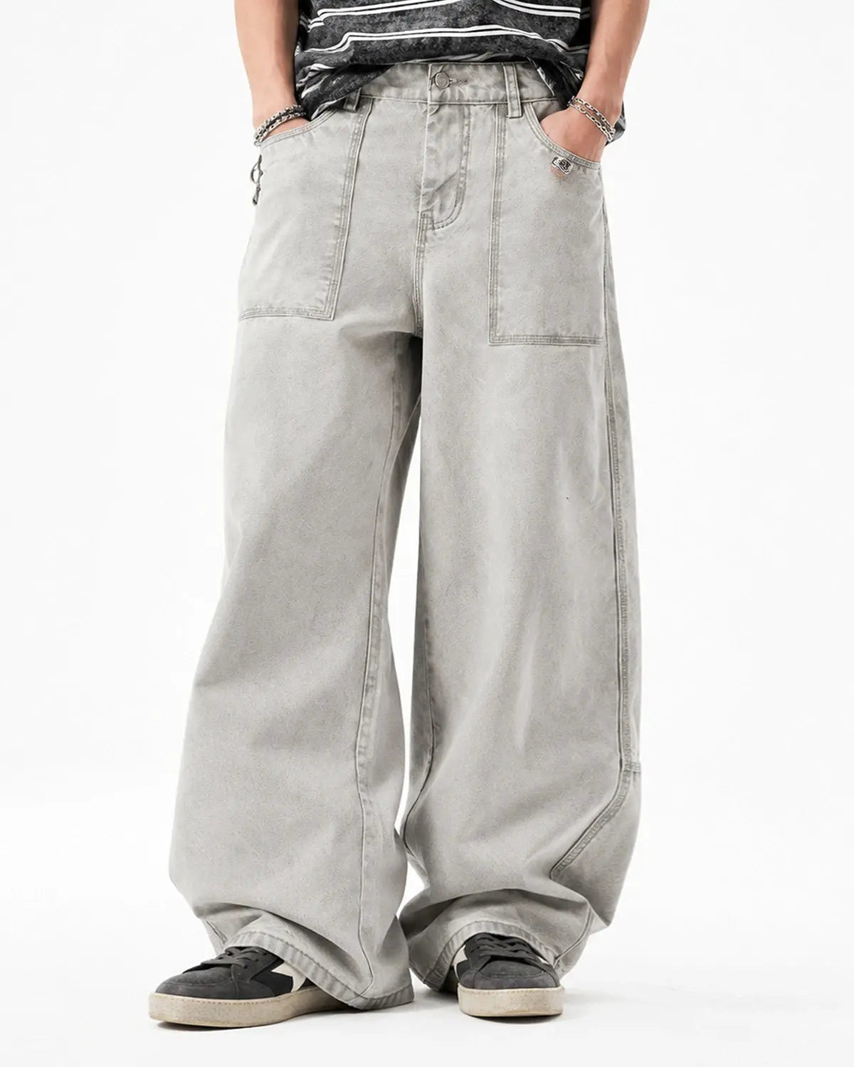 Deconstructed distressed barrel jeans by INFLATION Streetwear featuring ripped details and a relaxed fit on a model.