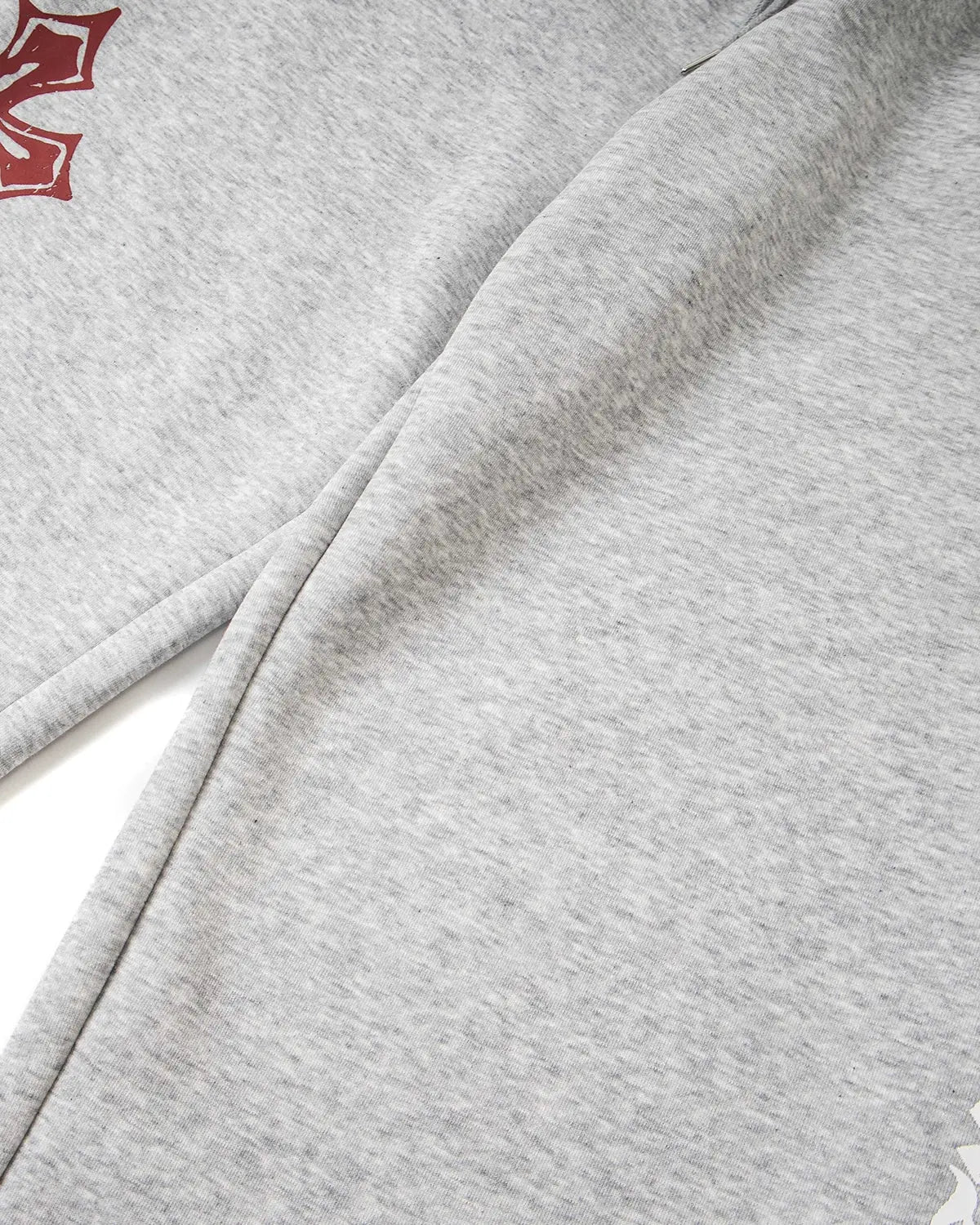Inflation Streetwear cross print baggy sweatpants with relaxed fit and bold graphic design, ideal for casual streetwear style.