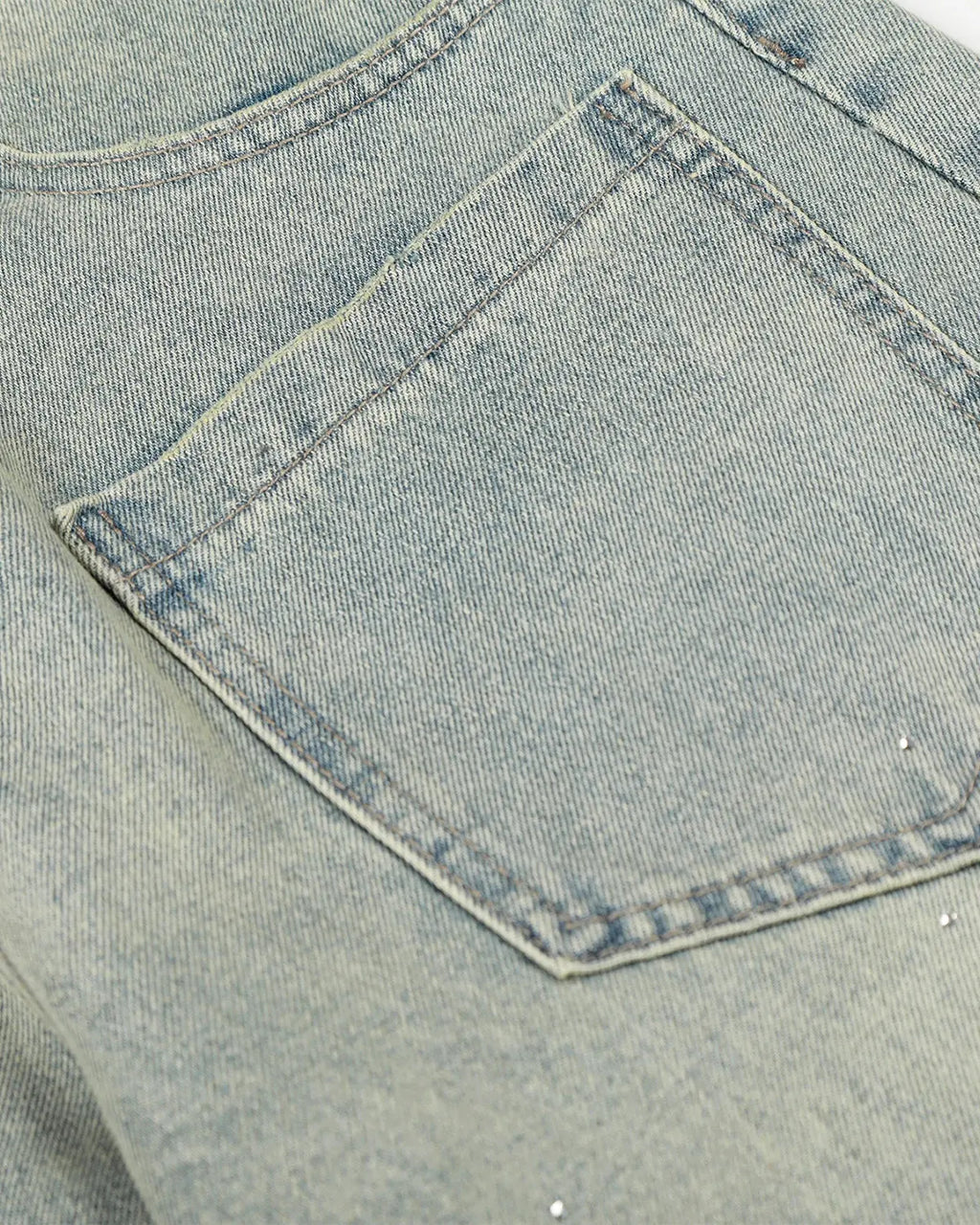 Acid wash rhinestone baggy jeans by INFLATION featuring distressed denim, rhinestone embellishments, and a relaxed streetwear style.