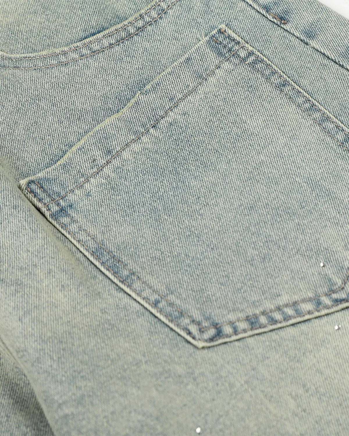 Acid wash rhinestone baggy jeans by INFLATION featuring distressed denim, rhinestone embellishments, and a relaxed streetwear style.