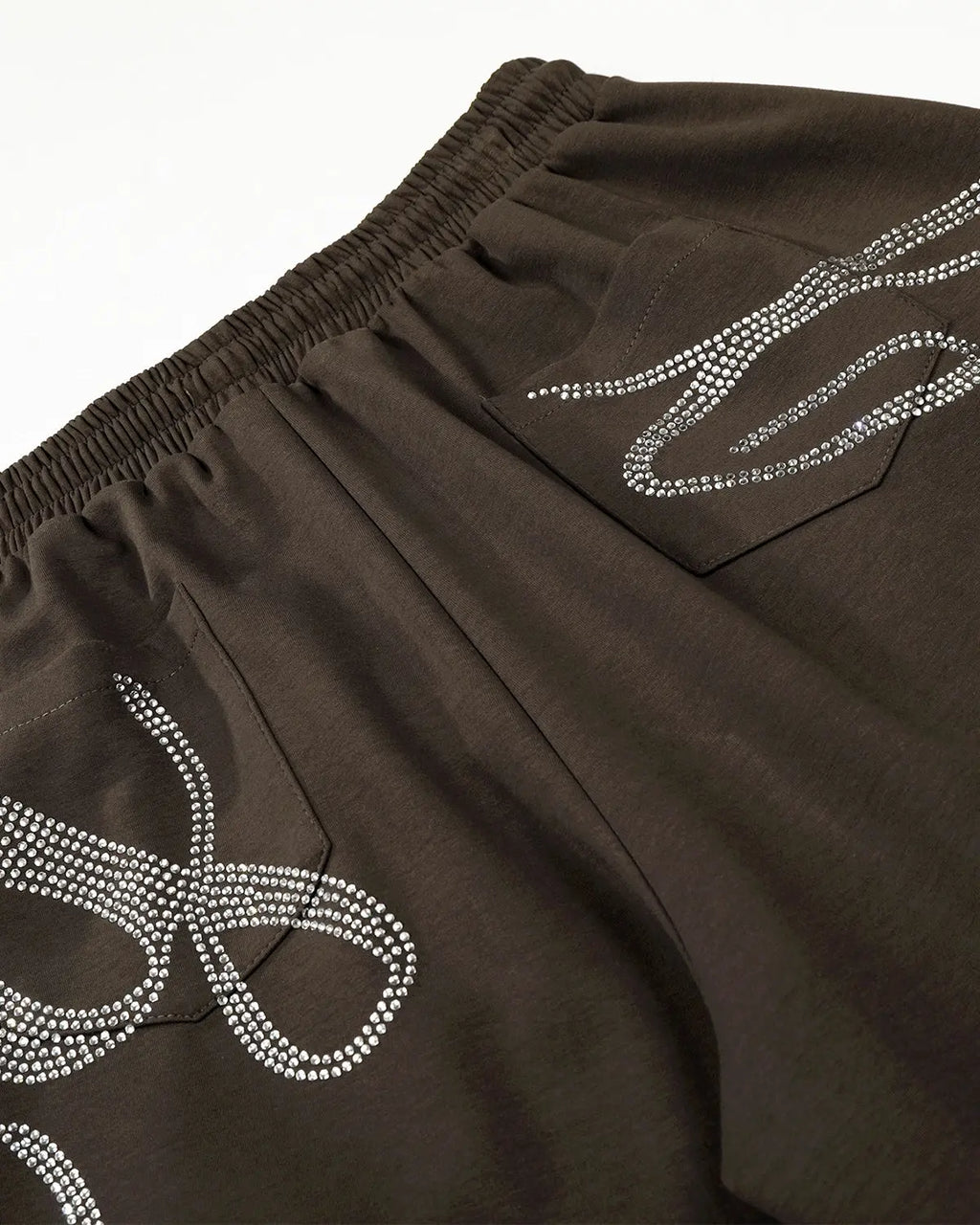 Rhinestone baggy joggers by INFLATION, streetwear style with sparkling rhinestone details and relaxed fit, front view.