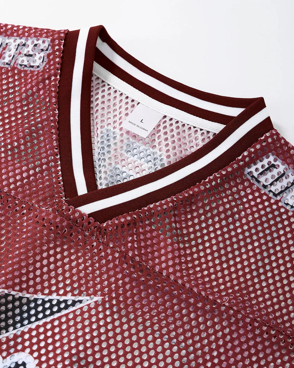 V-neck graphic mesh jersey by INFLATION Streetwear featuring bold designs and breathable fabric for a stylish urban look.