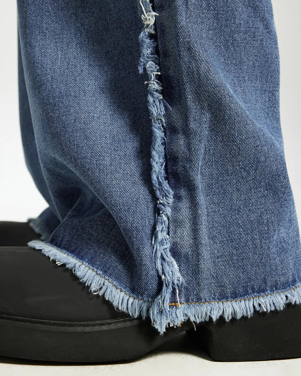 Blue frayed acid wash streetwear pants from Inflation, featuring a relaxed fit and distressed detailing on the fabric.