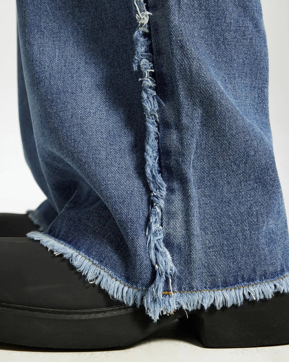 Blue frayed acid wash streetwear pants from Inflation, featuring a relaxed fit and distressed detailing on the fabric.