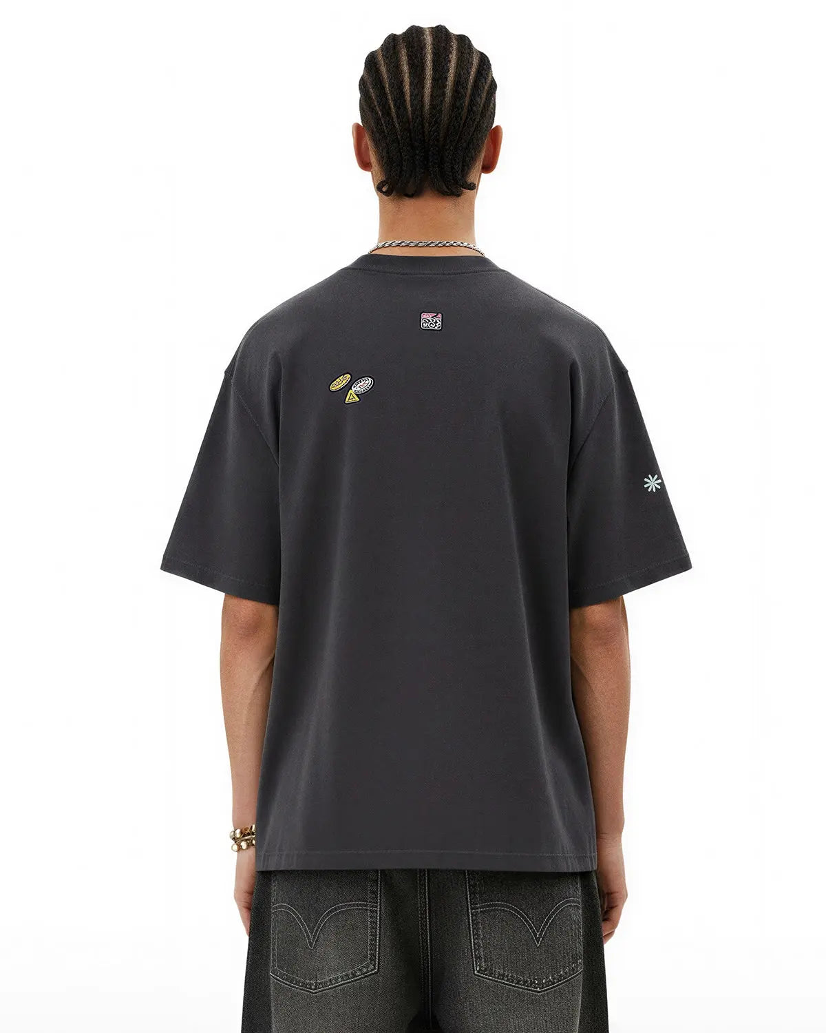 Vintage sticker graphic oversized T-shirt by INFLATION featuring bold streetwear design and colorful retro-inspired imagery.