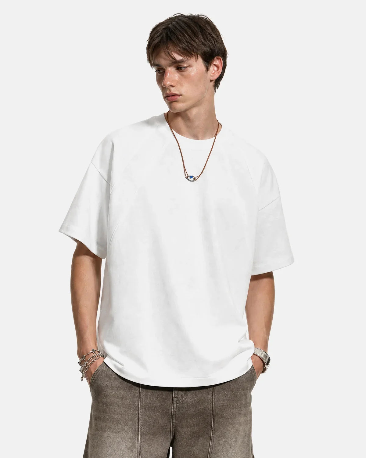 Boxy deconstructed T-shirt by INFLATION, featuring a relaxed fit and modern streetwear style, shown on a plain background.