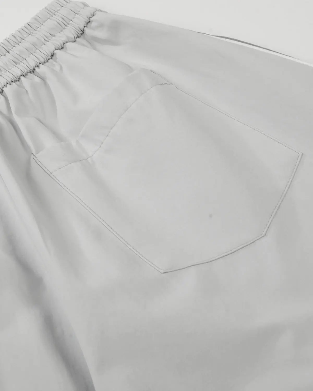 Inflation Contrast Panel Baggy Track Pants featuring black and white color blocks, relaxed fit, and stylish streetwear design.