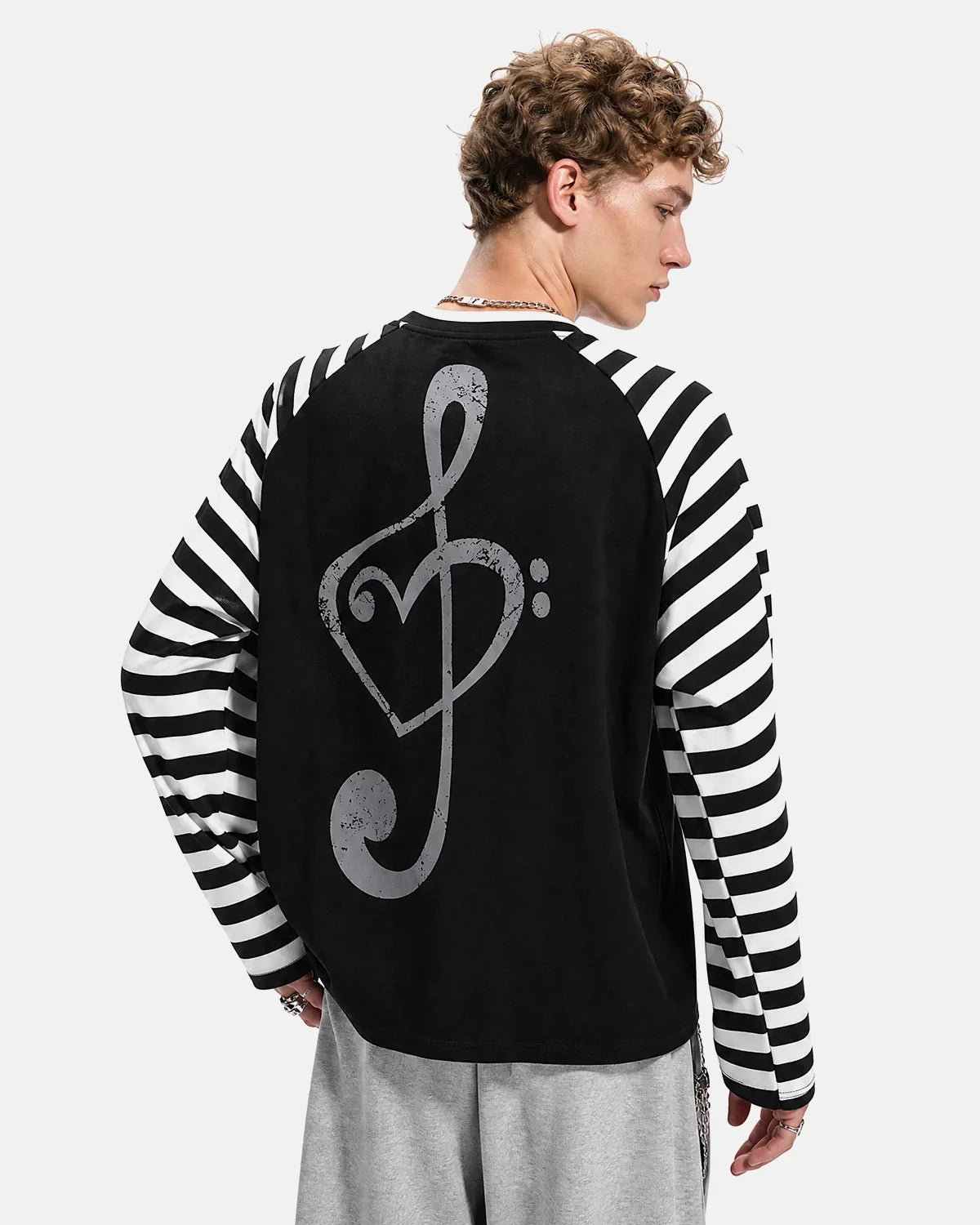 Inflation Streetwear music graphic striped long sleeve T-shirt featuring bold musical note design on black and white striped fabric.