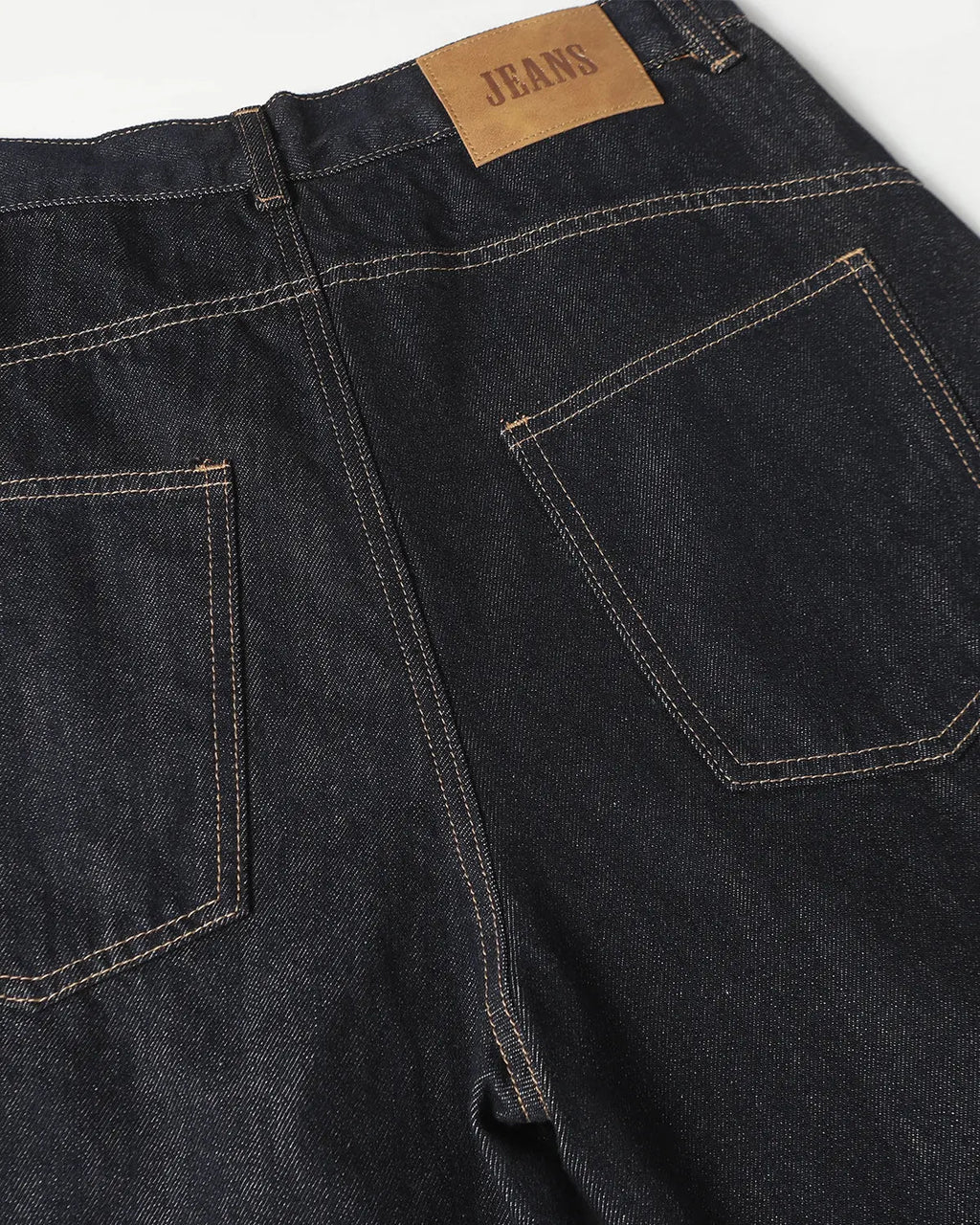 Deconstructed scimitar denim longline jorts by INFLATION, featuring distressed details and a unique, elongated cut on pants.