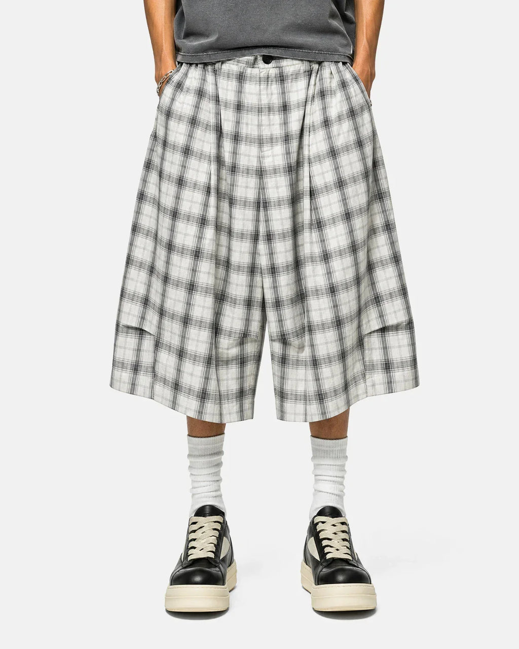 Inflation brand plaid longline casual shorts with a relaxed fit and checkered pattern, perfect for streetwear fashion.