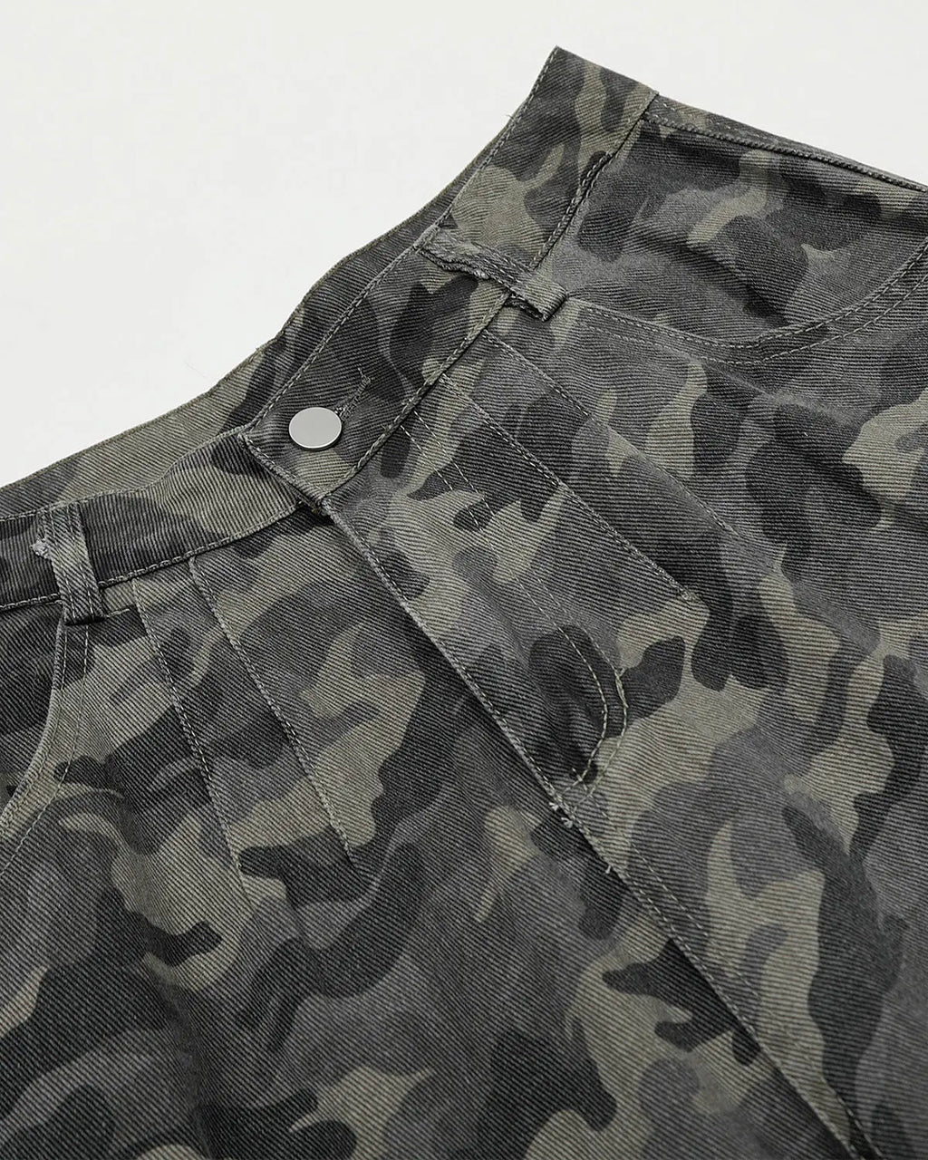 Embroidered camo cargo pants by INFLATION featuring multiple pockets and military-style camouflage fabric.