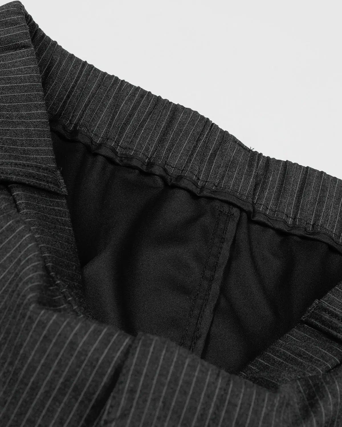 Inflation Streetwear pinstripe tailored shorts with stud detail, featuring a sleek, fitted design perfect for casual or streetwear fashion.