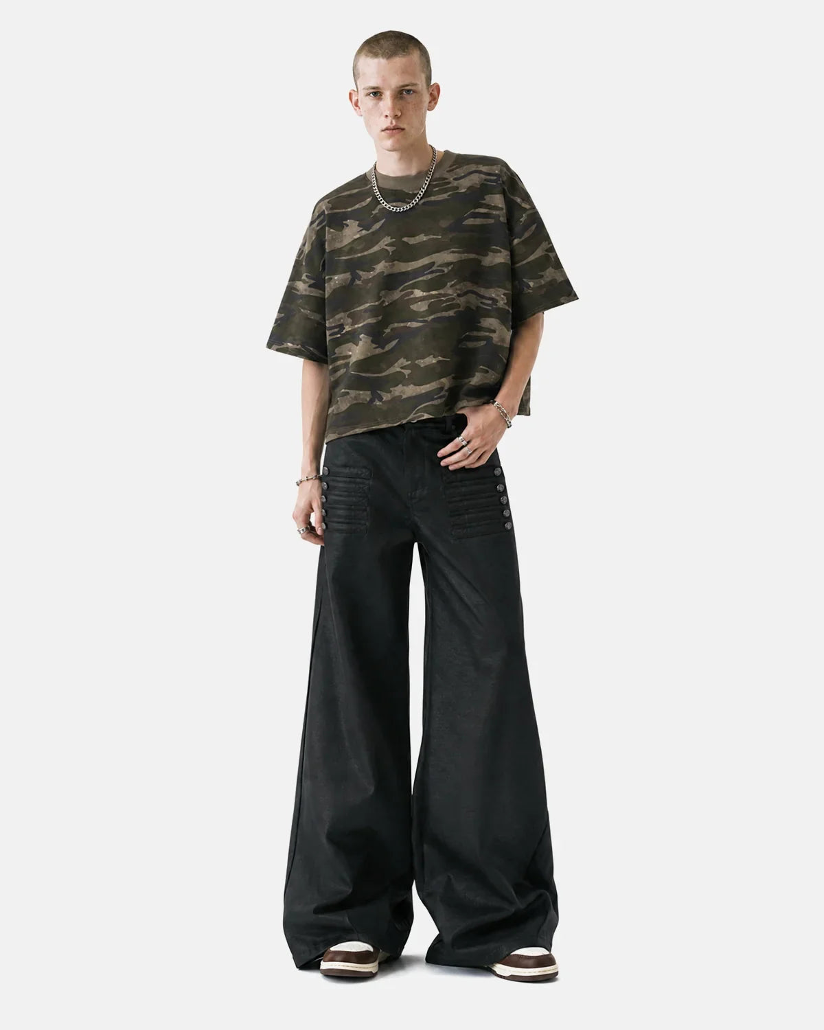 Black graphic wide-leg pants by INFLATION streetwear featuring bold design and relaxed fit, shown on a model.