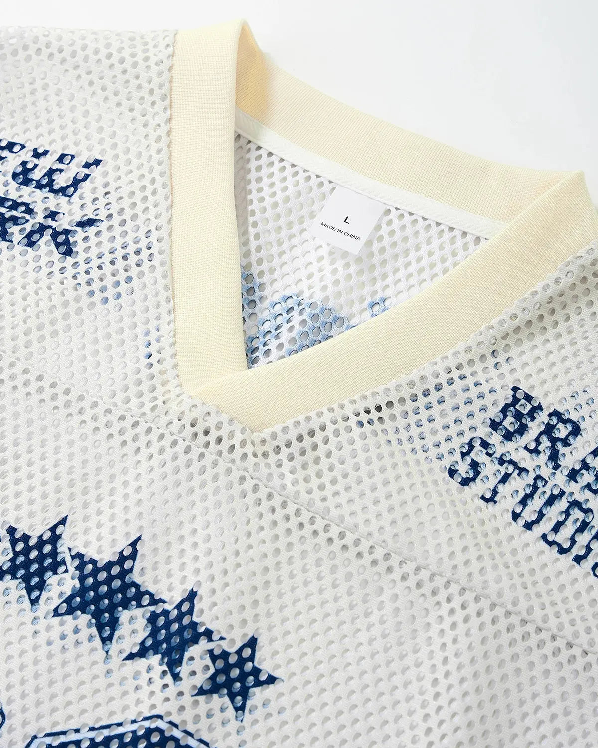 Star graphic oversized mesh jersey by INFLATION featuring a bold star print and breathable mesh fabric for streetwear style.