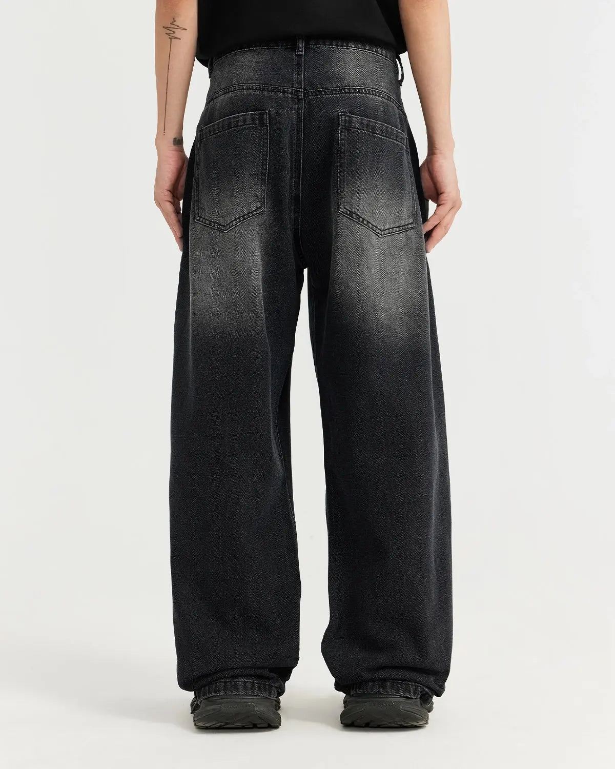 Black washed baggy jeans by Inflation Streetwear with a relaxed fit and distressed details, displayed on a mannequin.