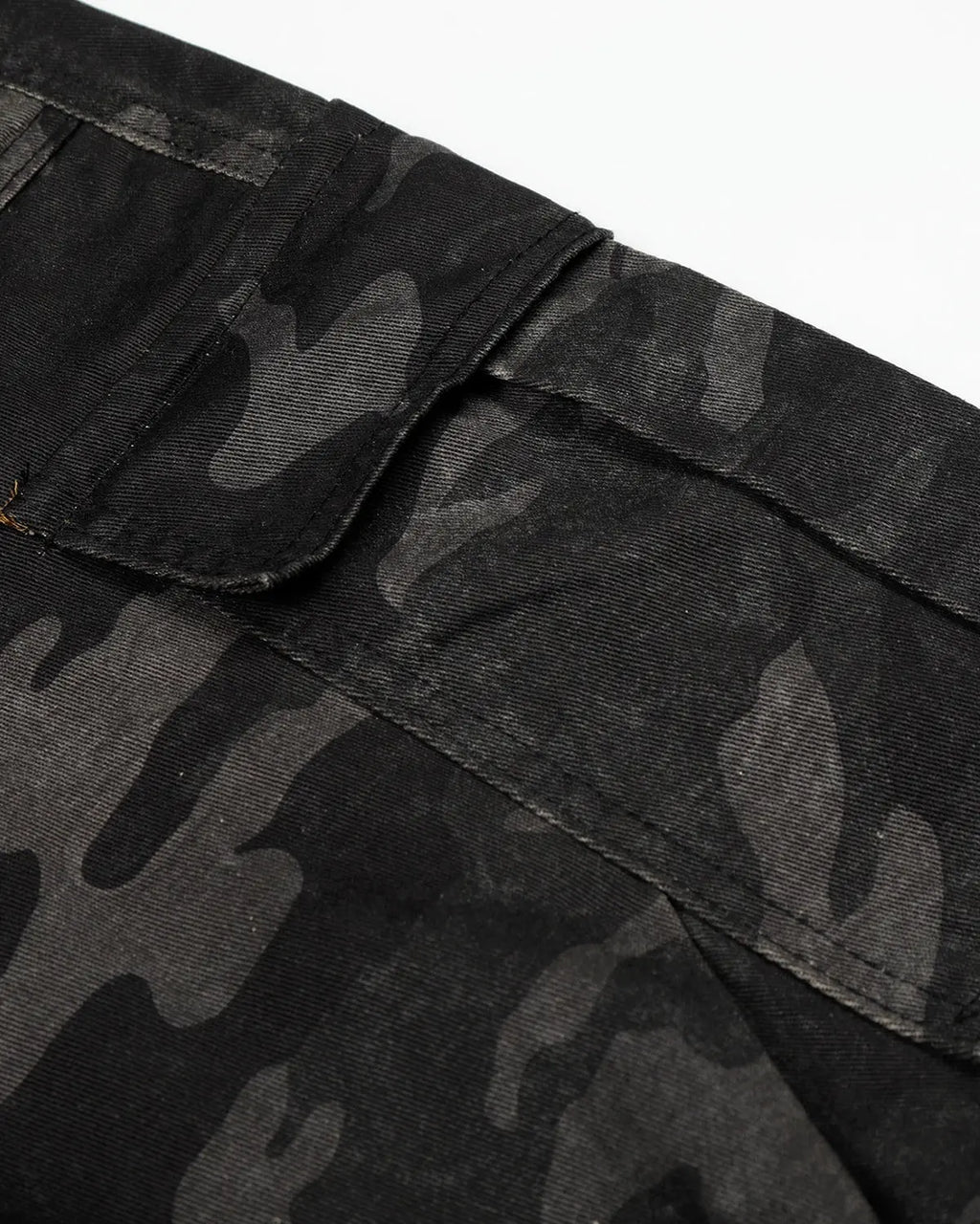 Dark camo cargo shorts by INFLATION, featuring multiple pockets and a relaxed fit, displayed on a neutral background.