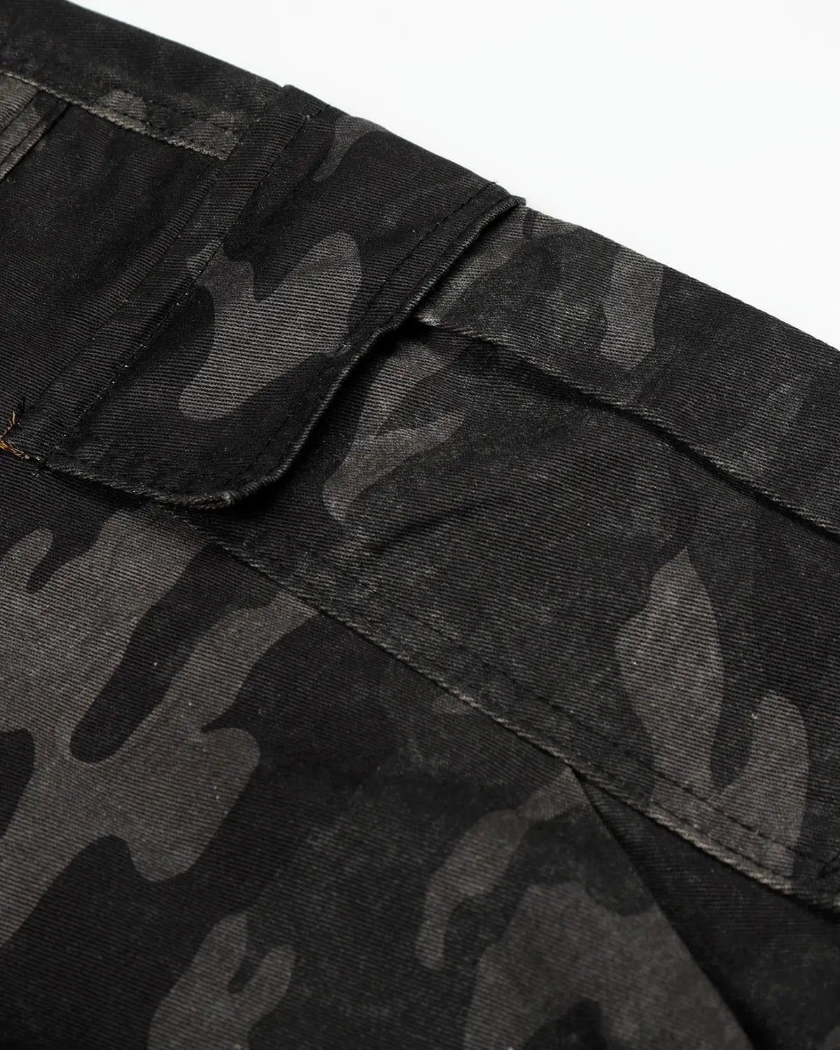 Dark camo cargo shorts by INFLATION, featuring multiple pockets and a relaxed fit, displayed on a neutral background.