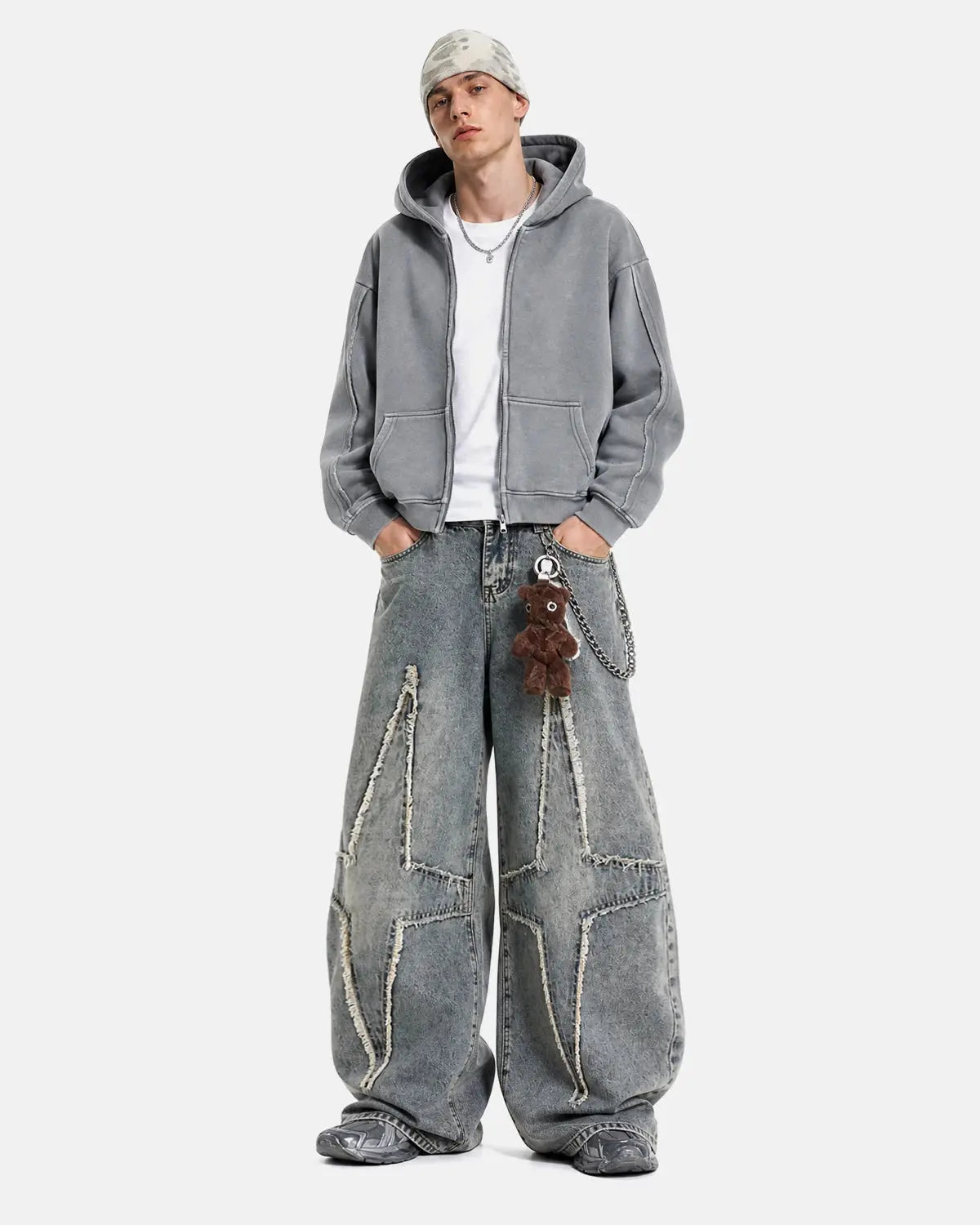 Star patched baggy jeans from INFLATION streetwear with a relaxed fit, distressed details, and star patches on light denim fabric.