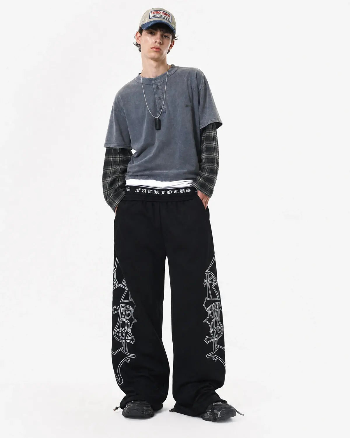 Gothic layered baggy sweatpants by INFLATION with a relaxed fit, black fabric, and streetwear style, shown on a model.