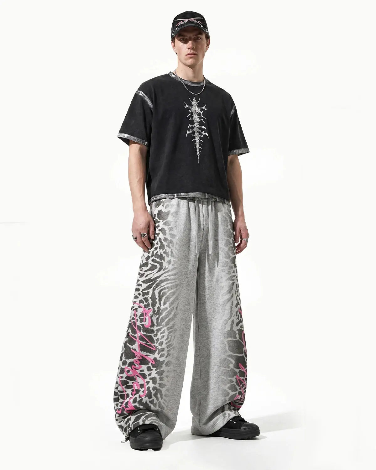 Leopard graphic barrel sweatpants by INFLATION featuring bold animal print and relaxed streetwear style.