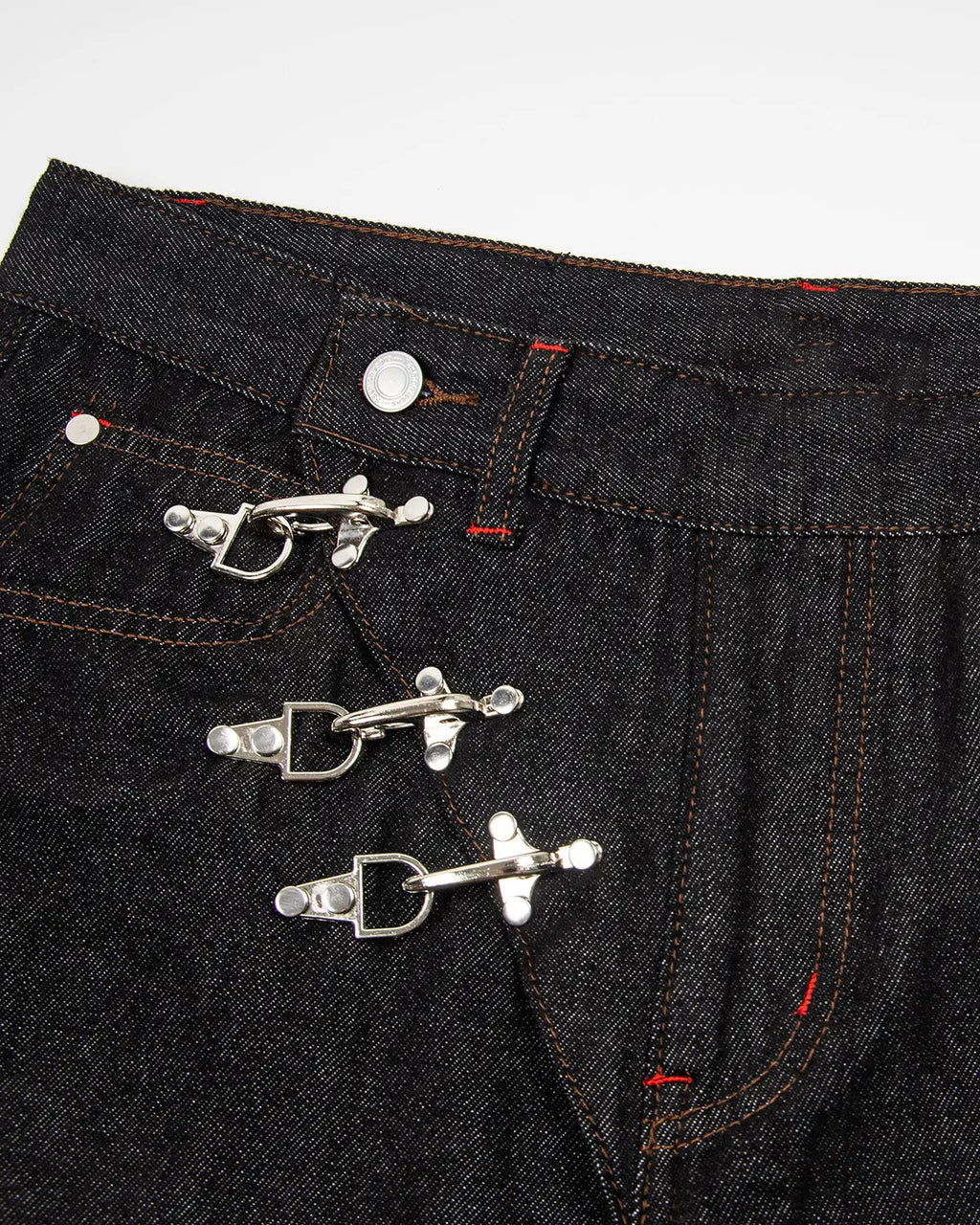 Asymmetric buckle raw baggy jeans by INFLATION featuring a relaxed fit and distinctive asymmetrical buckle design.