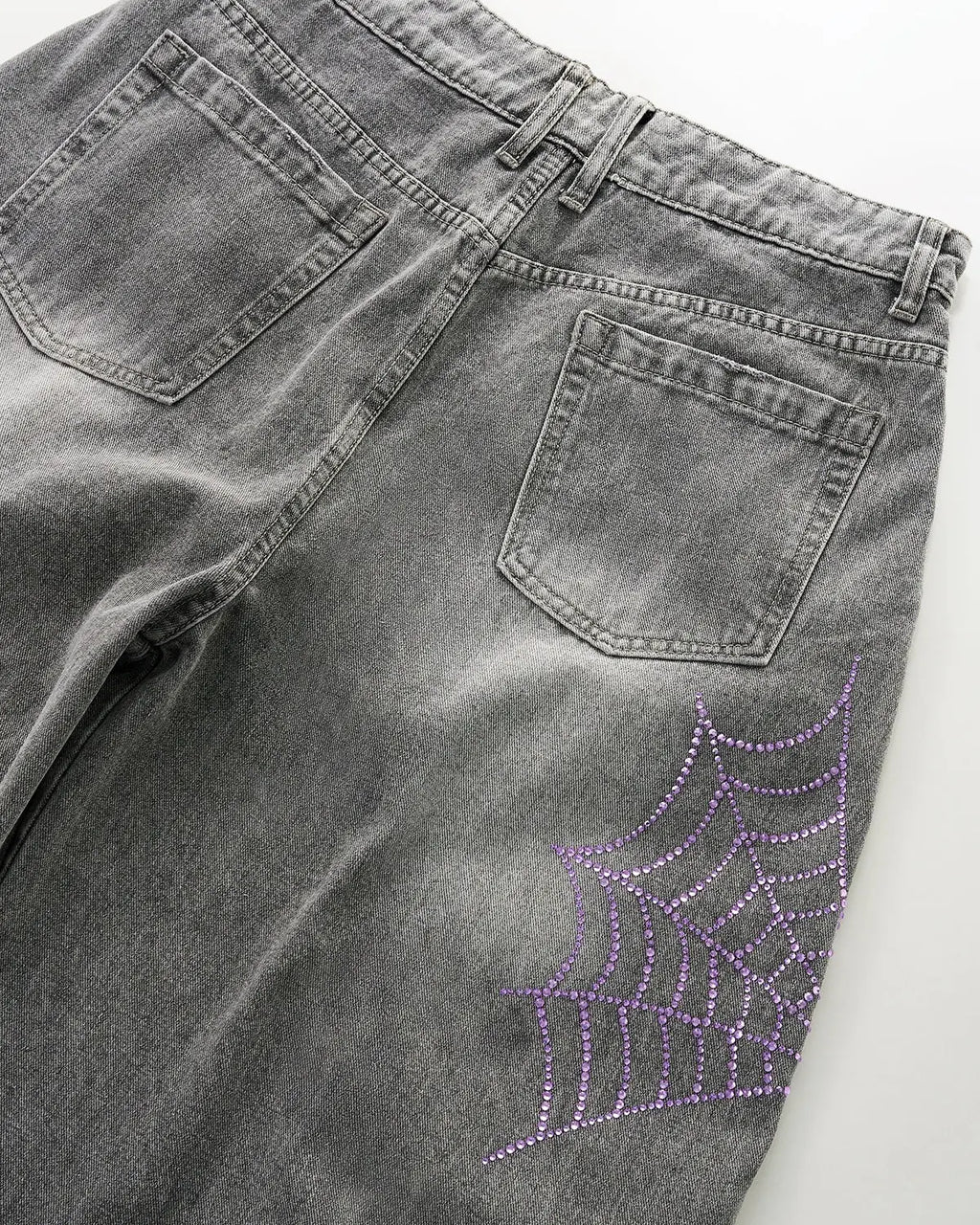 Inflation Spider Graphic Rhinestone Barrel Jeans displaying a bold spider graphic and rhinestone embellishments on stylish denim pants.
